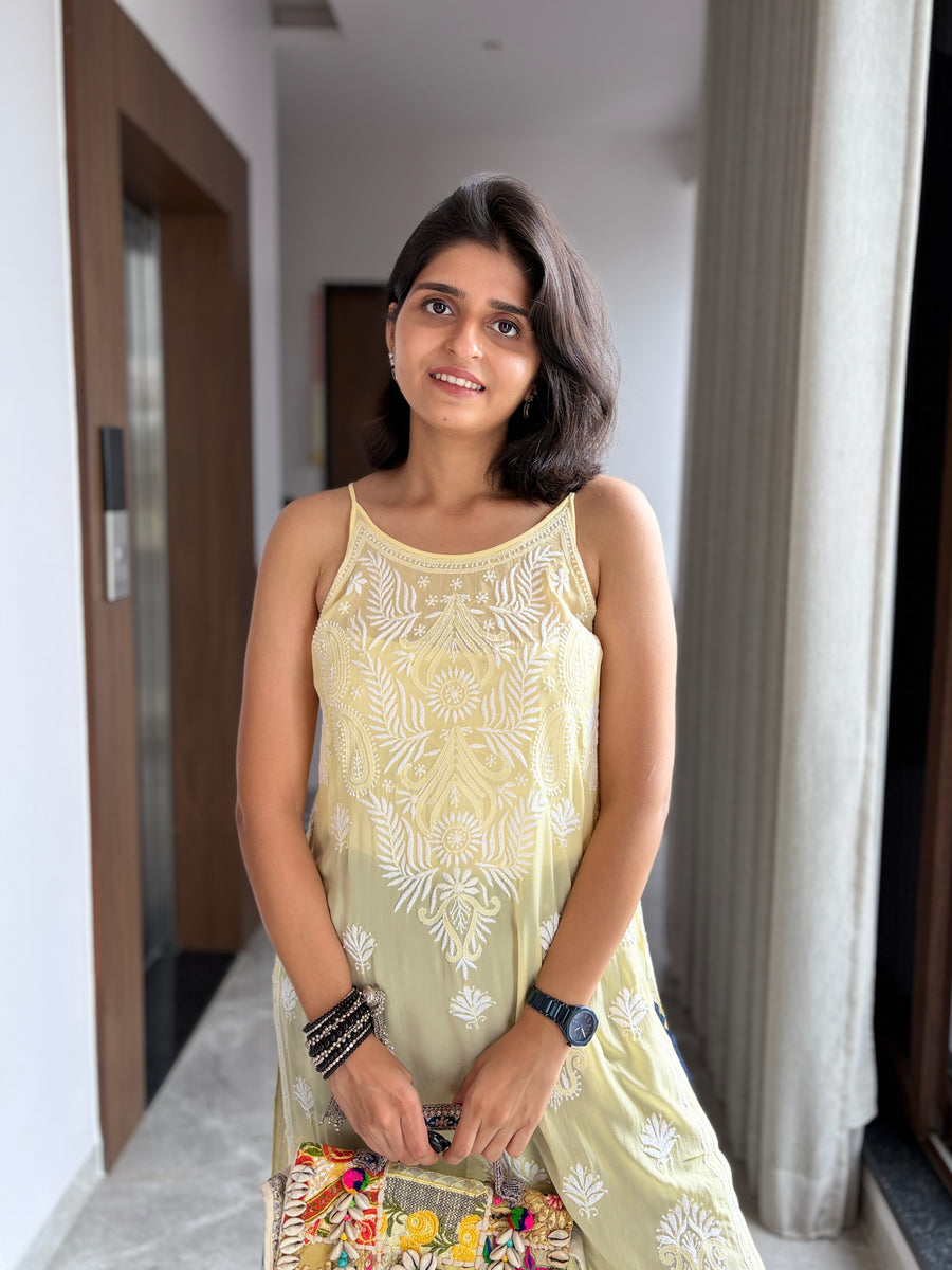 Yellow viscose noodle strap chikankari kurta - front view with embroidered clutch bag
